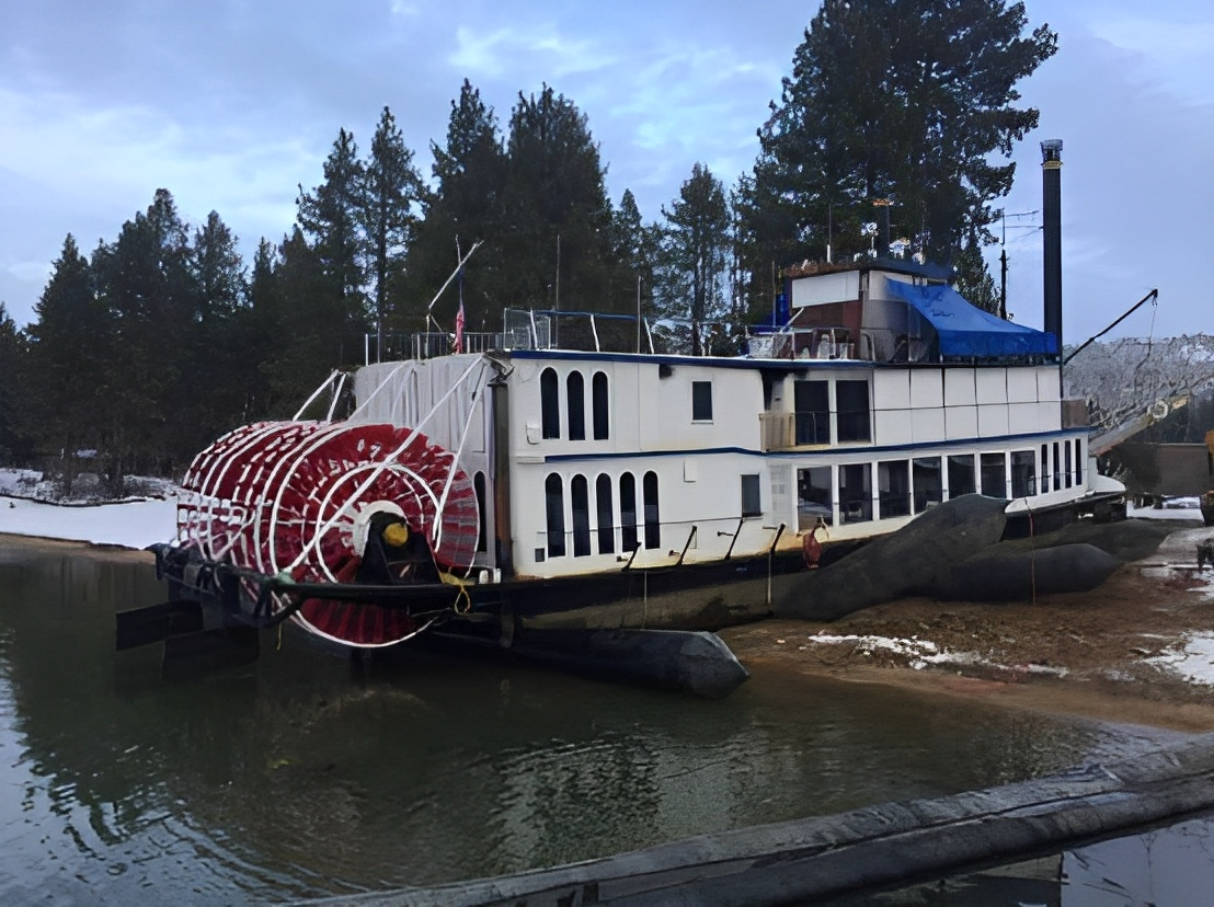 A paddle steamer pulled up onto shore